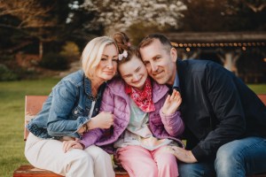 In the Comox Valley, Paula, Mike and daughter Elllie. Born with a rare neurogenetic disorder, Ellie is thriving with support from Bear Essentials, a family support program that assists with the costs of health-related travel and equipment for Island kids.