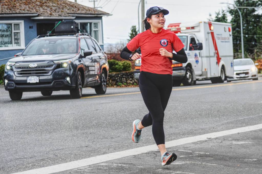 Wounded Warrior Run BC&rsquo;s head runner Nathalie Butler leads the team into the Town of Qualicum Beach.